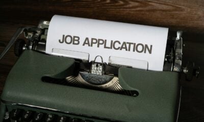 a typewriter with a job application printed on it