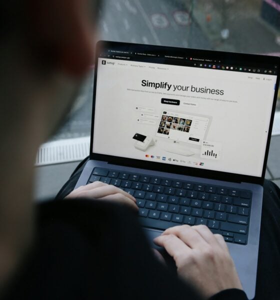 A man sitting on a bench using a laptop computer