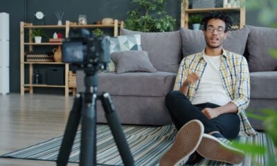 Man recording himself with a camera at home