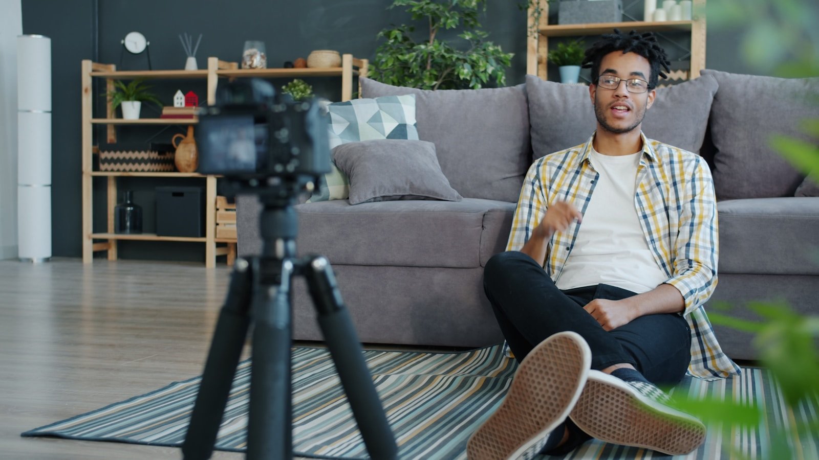 Man recording himself with a camera at home