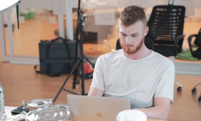 a man sitting at a table with a laptop