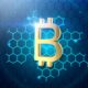 a golden bitcoin on a blue hexagonal background