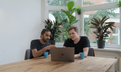 woman in blue crew neck t-shirt using silver macbook