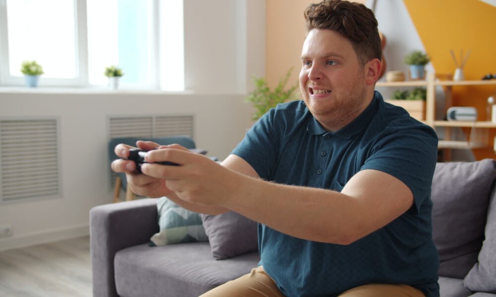 Man playing video games on a couch