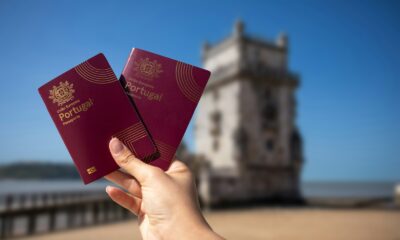 Holding two portuguese passports with a tower.