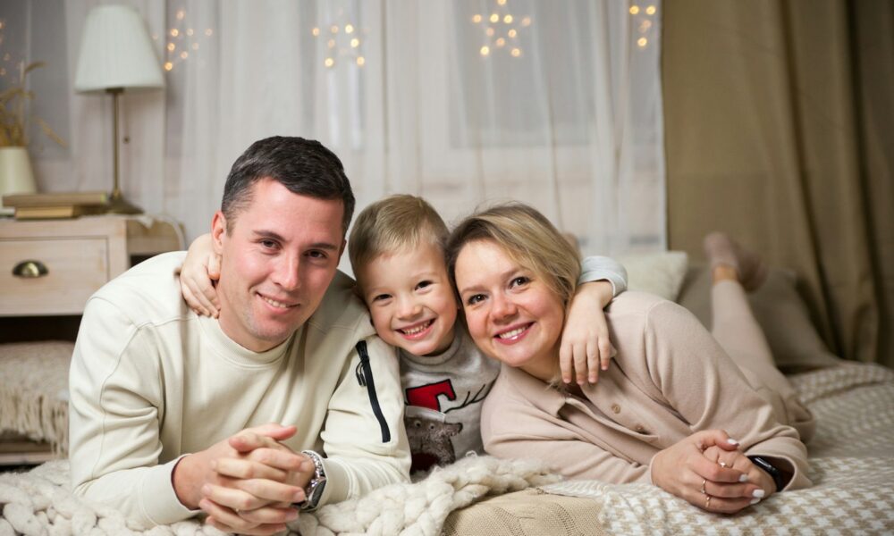 a man and woman with a couple of children on a bed