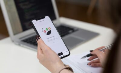 person holding space grey iPhone X turn on