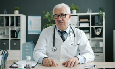 Doctor wearing a stethoscope at his desk