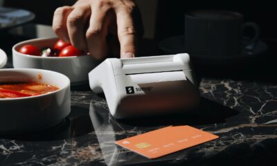 A person using a machine to cut tomatoes