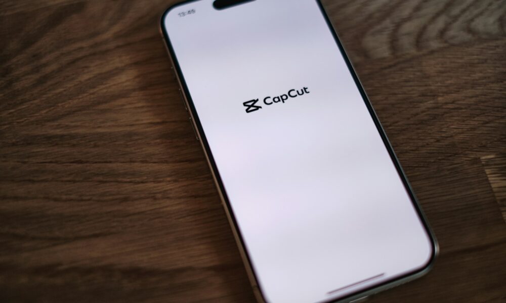 A close up of a cell phone on a wooden table
