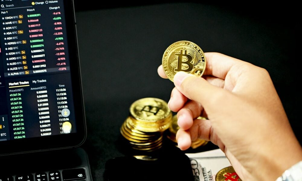 gold round coin on persons hand