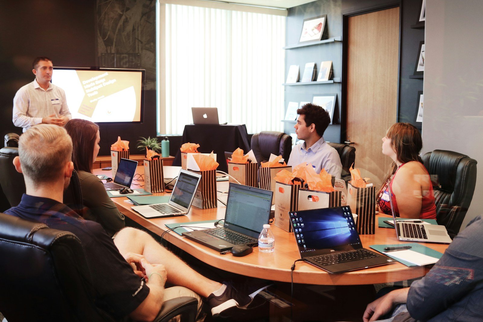 man standing in front of people sitting beside table with laptop computers | Credence Resource Management