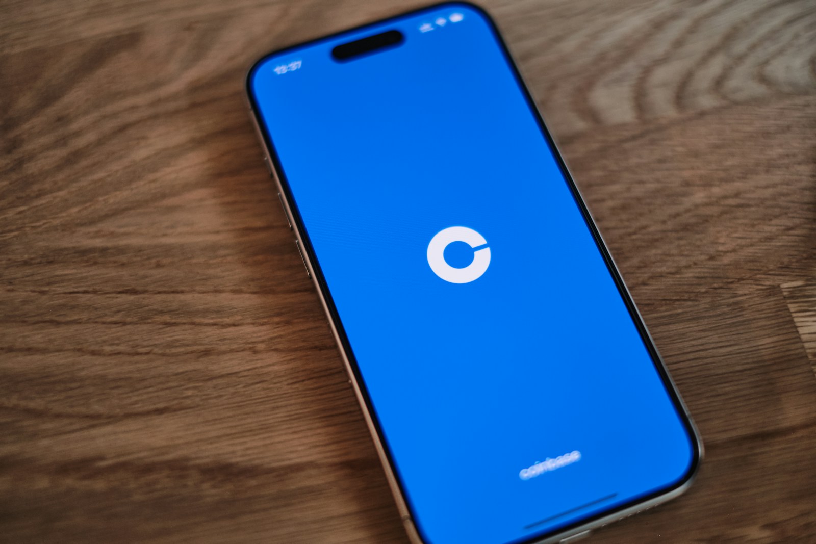 A cell phone sitting on top of a wooden table