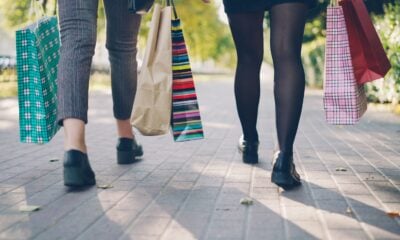 Two people walking with shopping bags