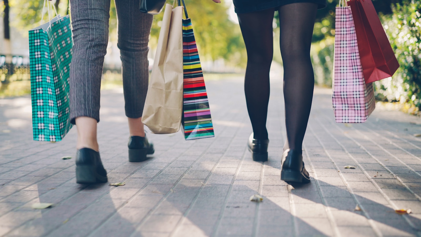 Two people walking with shopping bags