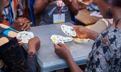 People playing a card game around a table