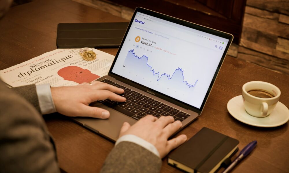 a person using a laptop on a wooden table