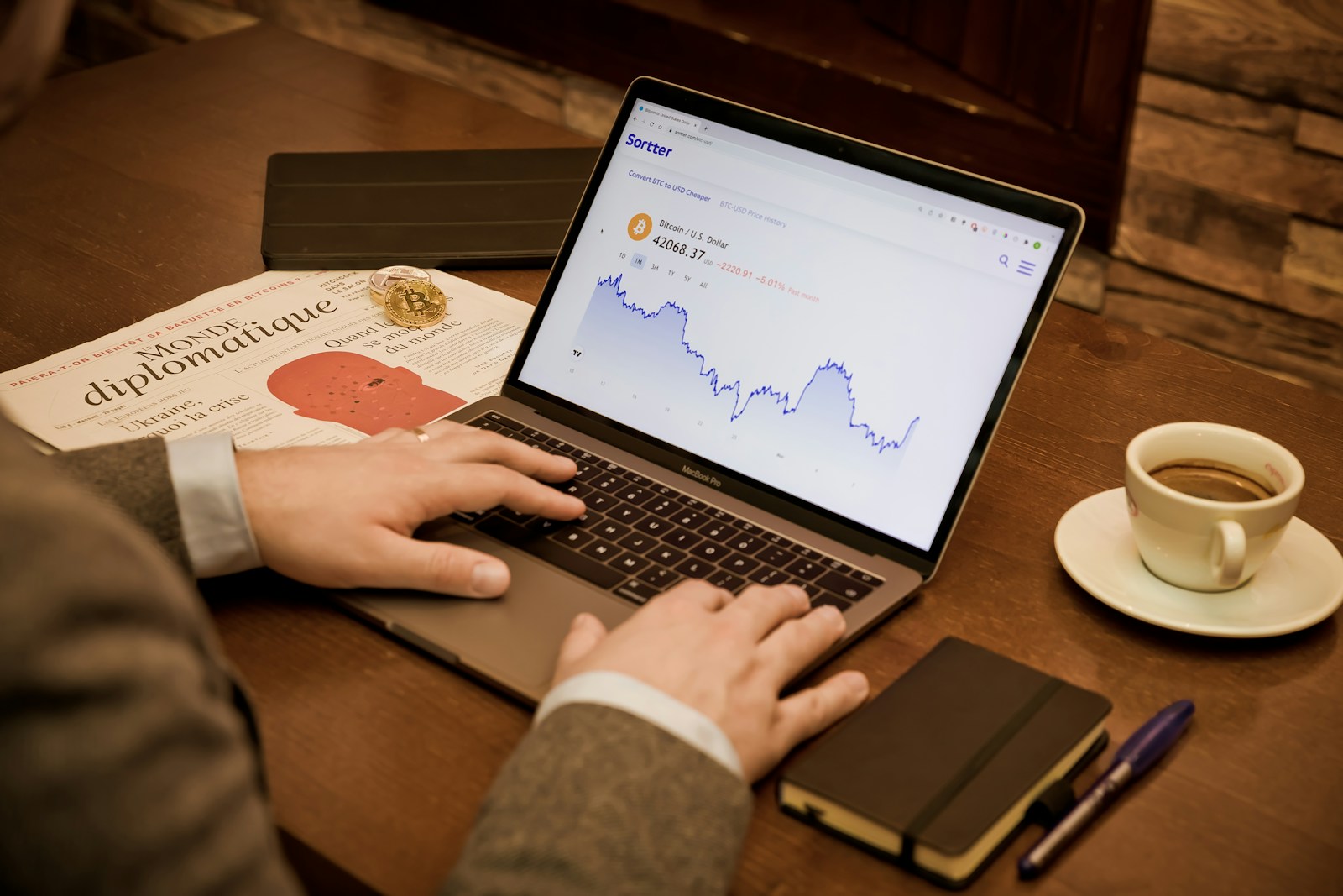 a person using a laptop on a wooden table
