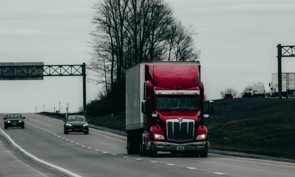 red and white truck on road during daytime