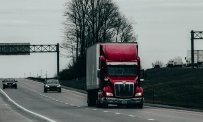 red and white truck on road during daytime