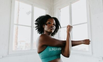 a woman in a sports bra top stretching her arms