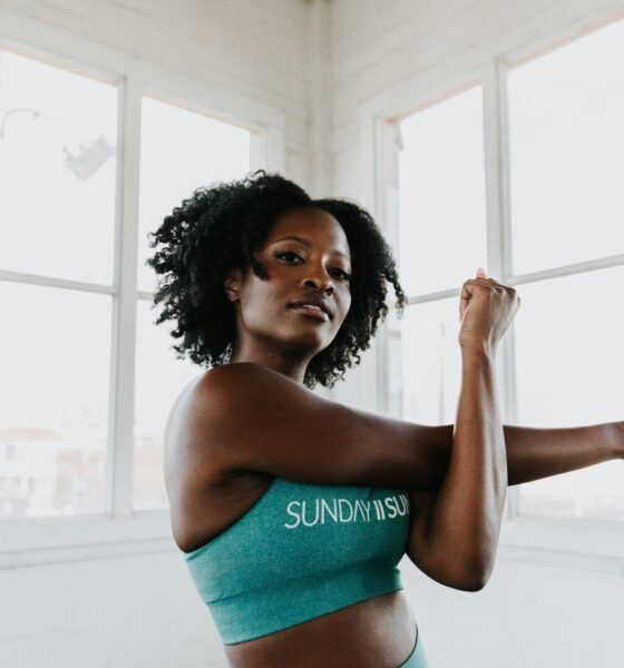 a woman in a sports bra top stretching her arms
