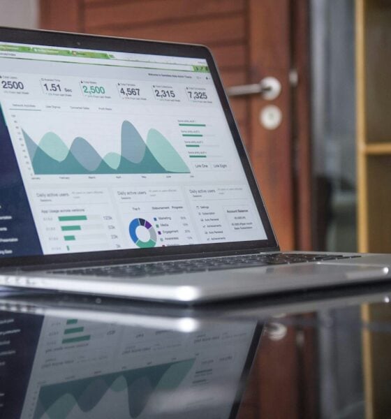 laptop computer on glass-top table. Grey Market Research
