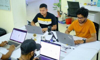people sitting at the table using laptops