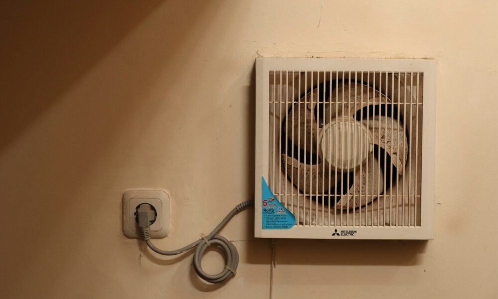 a wall mounted air conditioner mounted on a wall . how to make money in heating and air conditioning business