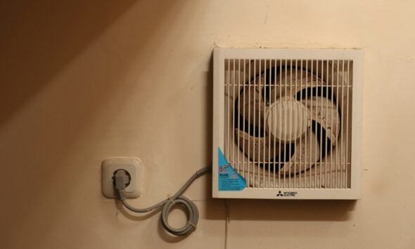 a wall mounted air conditioner mounted on a wall . how to make money in heating and air conditioning business