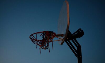 a basketball going through the rim of a basketball hoop