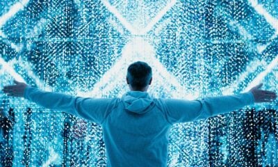 A man standing in front of a large display of numbers