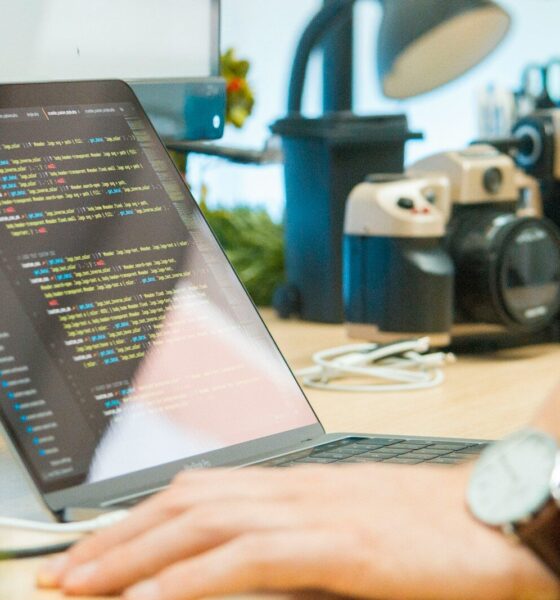 gray laptop computer on brown wooden desk