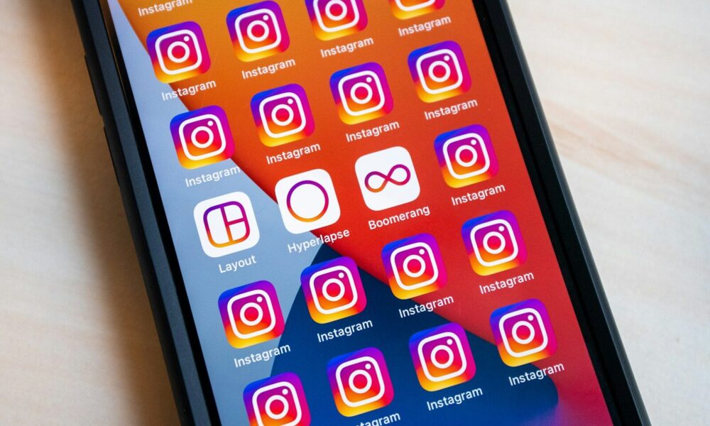 a cell phone with instagram stickers on the screen