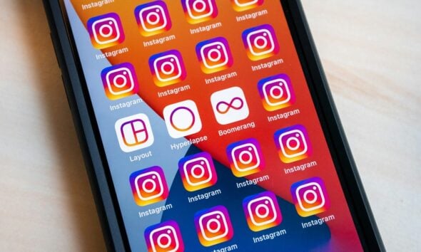 a cell phone with instagram stickers on the screen