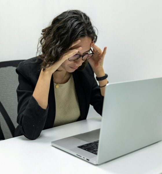 a woman sitting in front of a laptop computer