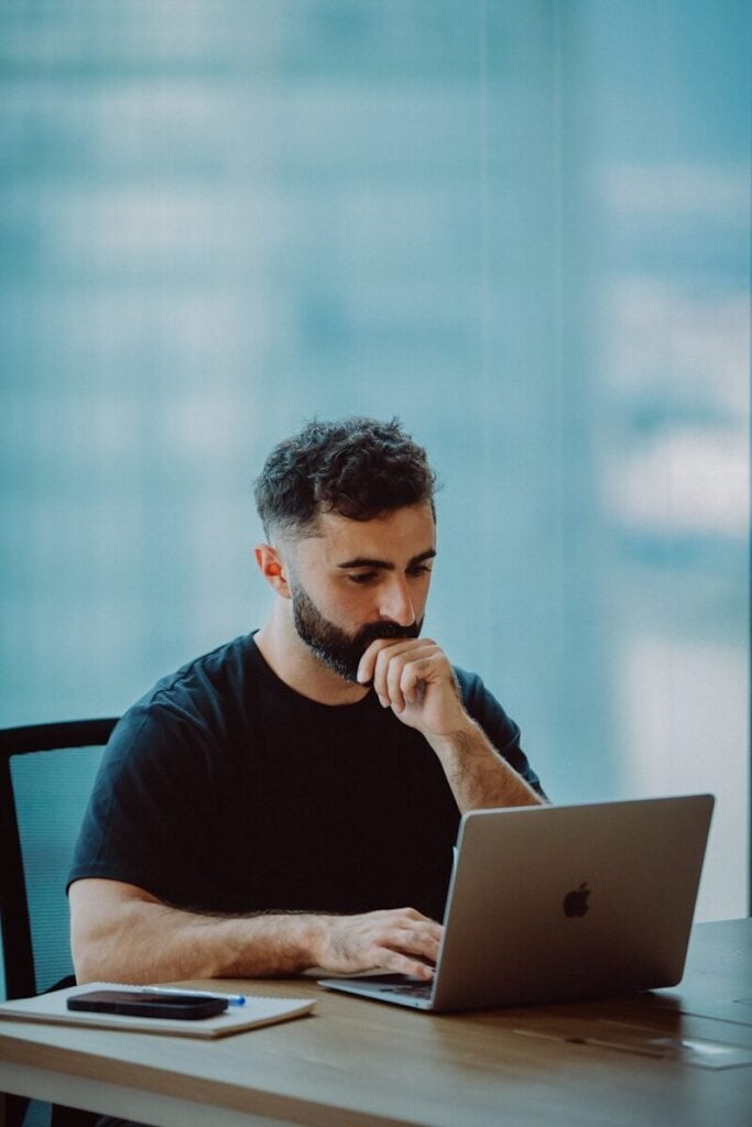 Man working on laptop in modern office setting