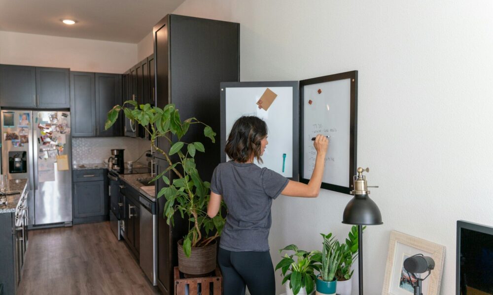 a woman standing in front of a refrigerator in a kitchen