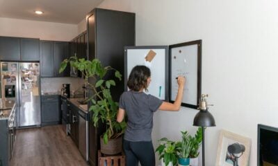 a woman standing in front of a refrigerator in a kitchen