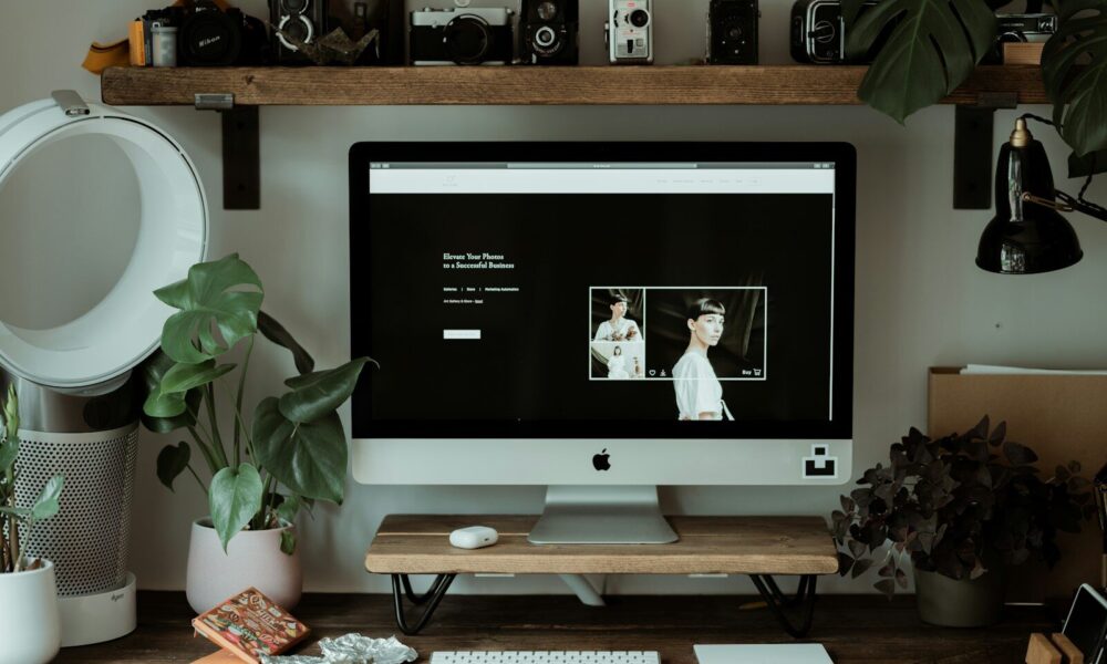 silver imac on brown wooden table