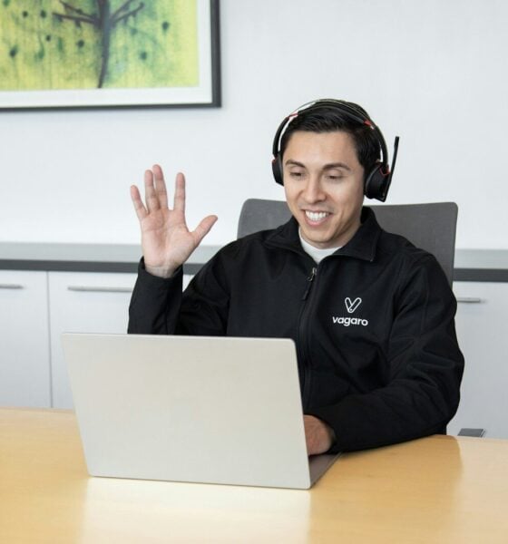 a man wearing headphones sitting in front of a laptop computer