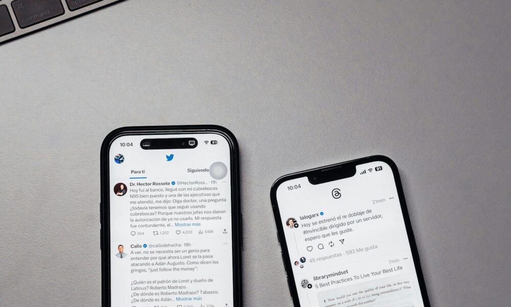 two iphones sitting next to each other on a table