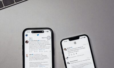 two iphones sitting next to each other on a table