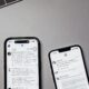 two iphones sitting next to each other on a table