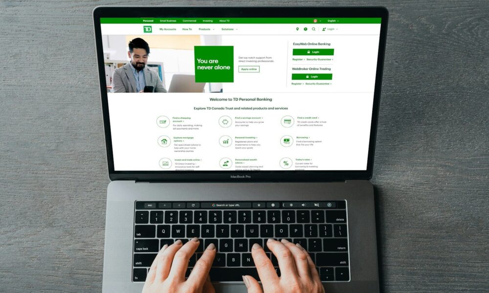 a person typing on a laptop with their hands