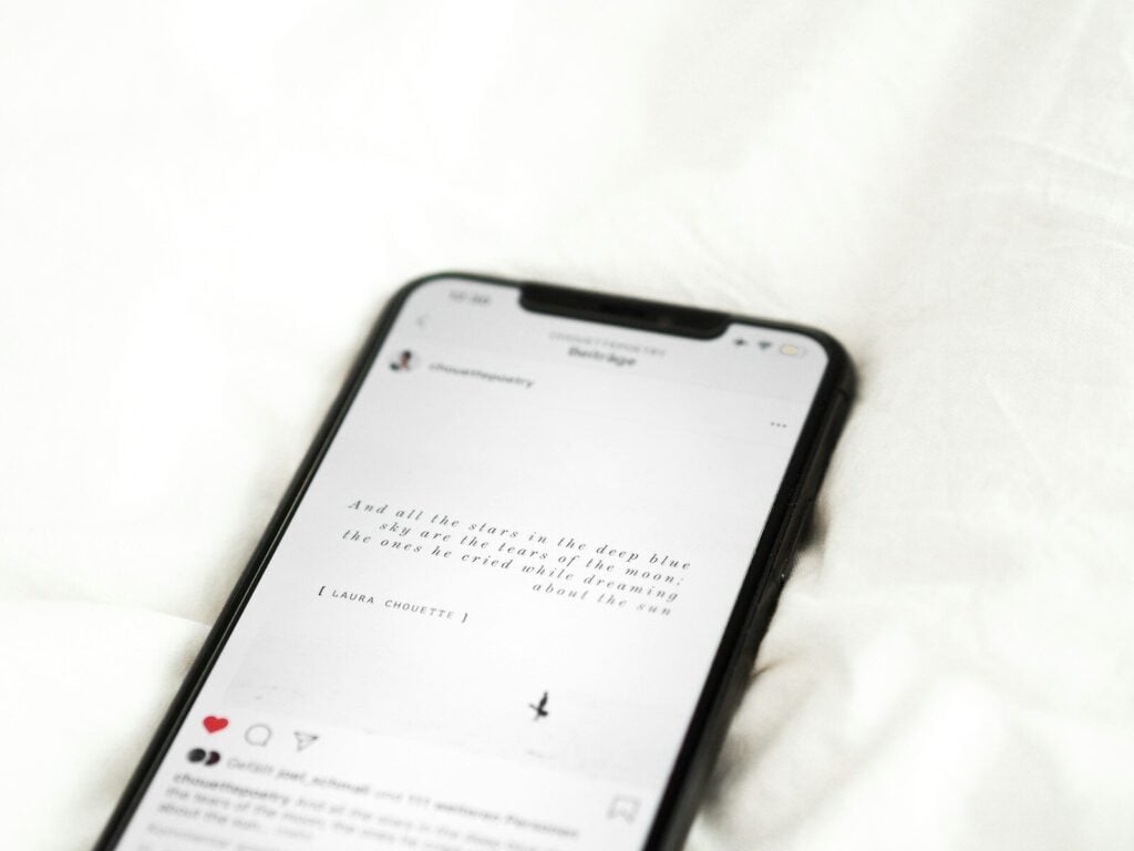 black android smartphone on white textile