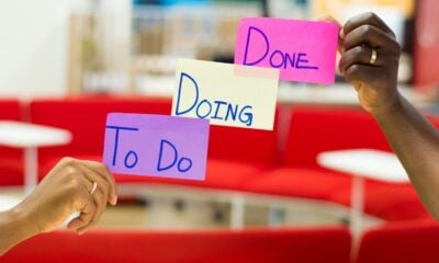 person holding purple and white card