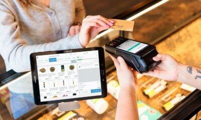 a woman is paying a card from a machine