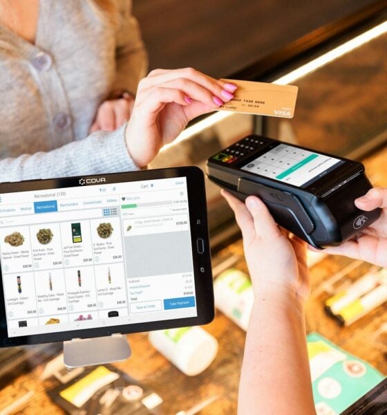 a woman is paying a card from a machine