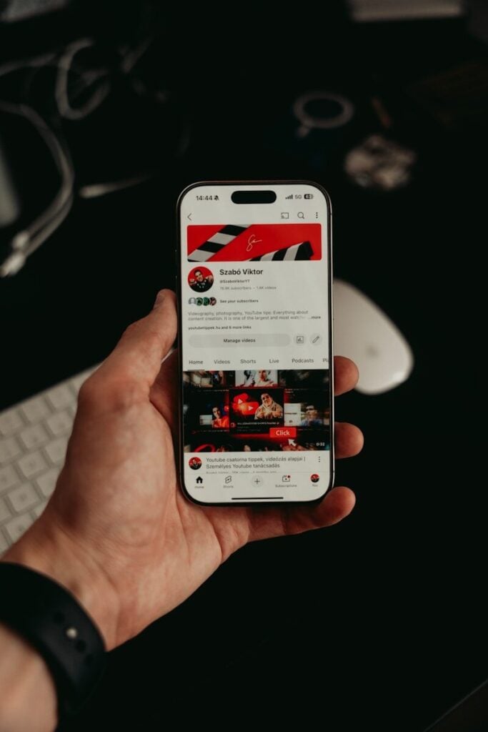 Itsnewztalkies com - Your Hub for Trending Stories 27 A hand holds a phone with a youtube profile.